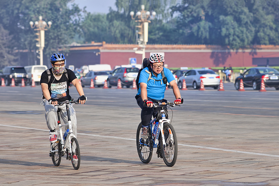 Two men biking in street